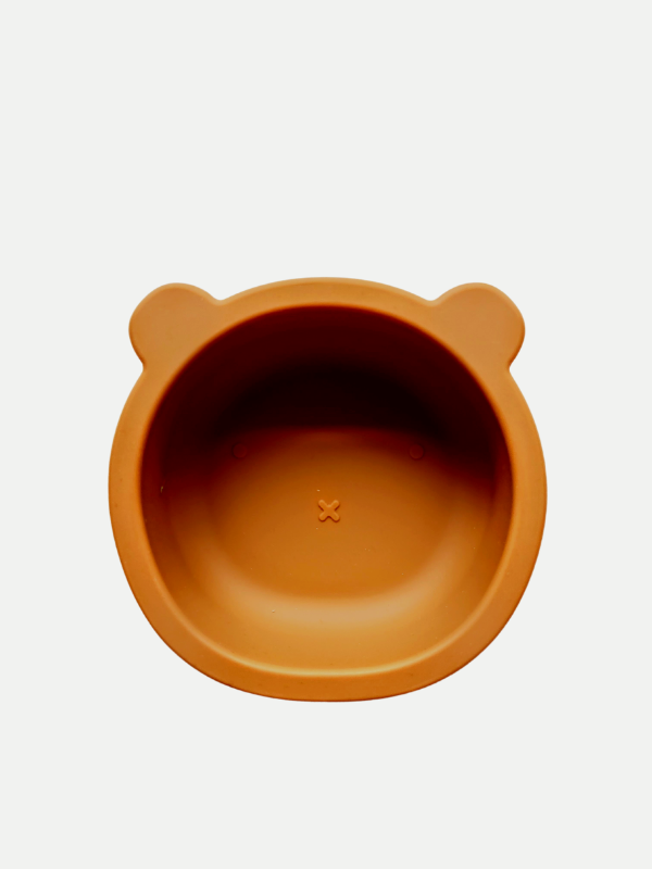 Burnt orange silicone bowl, with suction cup base, in the shape of a bear's face.