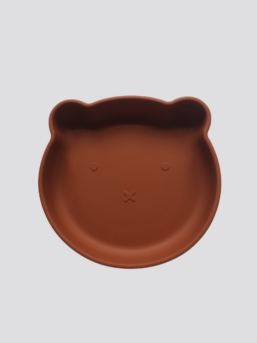 Clay brown silicone plate, with suction cup base, in the shape of a bear's face.