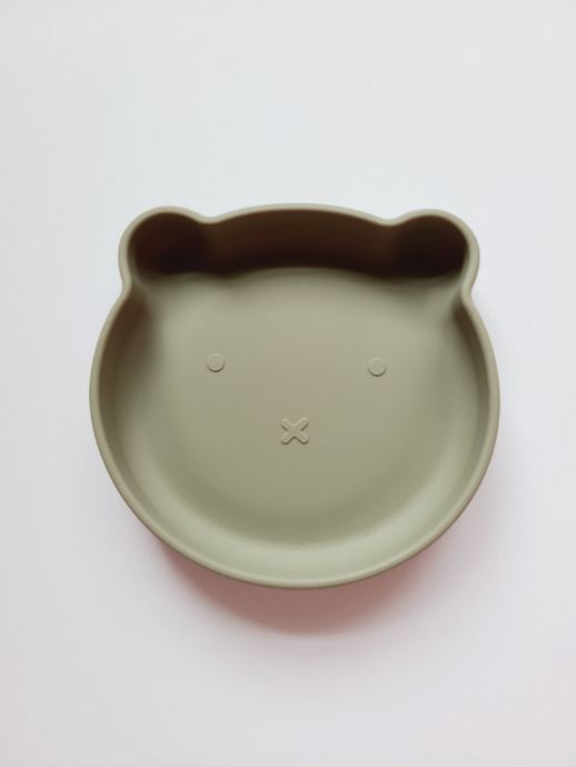 Green sage silicone plate, with suction cup base, in the shape of a bear's face.