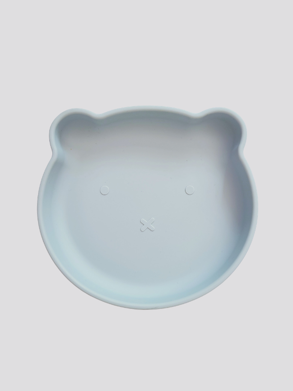 Grey blue silicone plate, with suction cup base, in the shape of a bear's face.