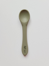 Load image into Gallery viewer, A small sage coloured silicone spoon meant for use by babies and toddlers.

