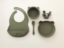 Load image into Gallery viewer, A silicone bib, spoon, bear plate, bear bowl, and baby utensils (fork and spoon) in a sage green colour. All the items are meant for use by babies or toddlers.
